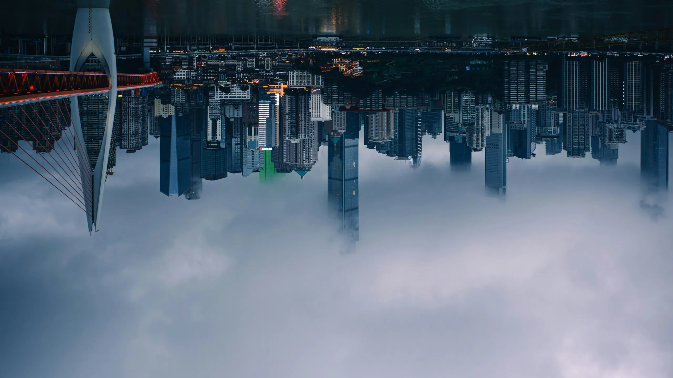 An upside-down city skyline hanging above a sea of cloud